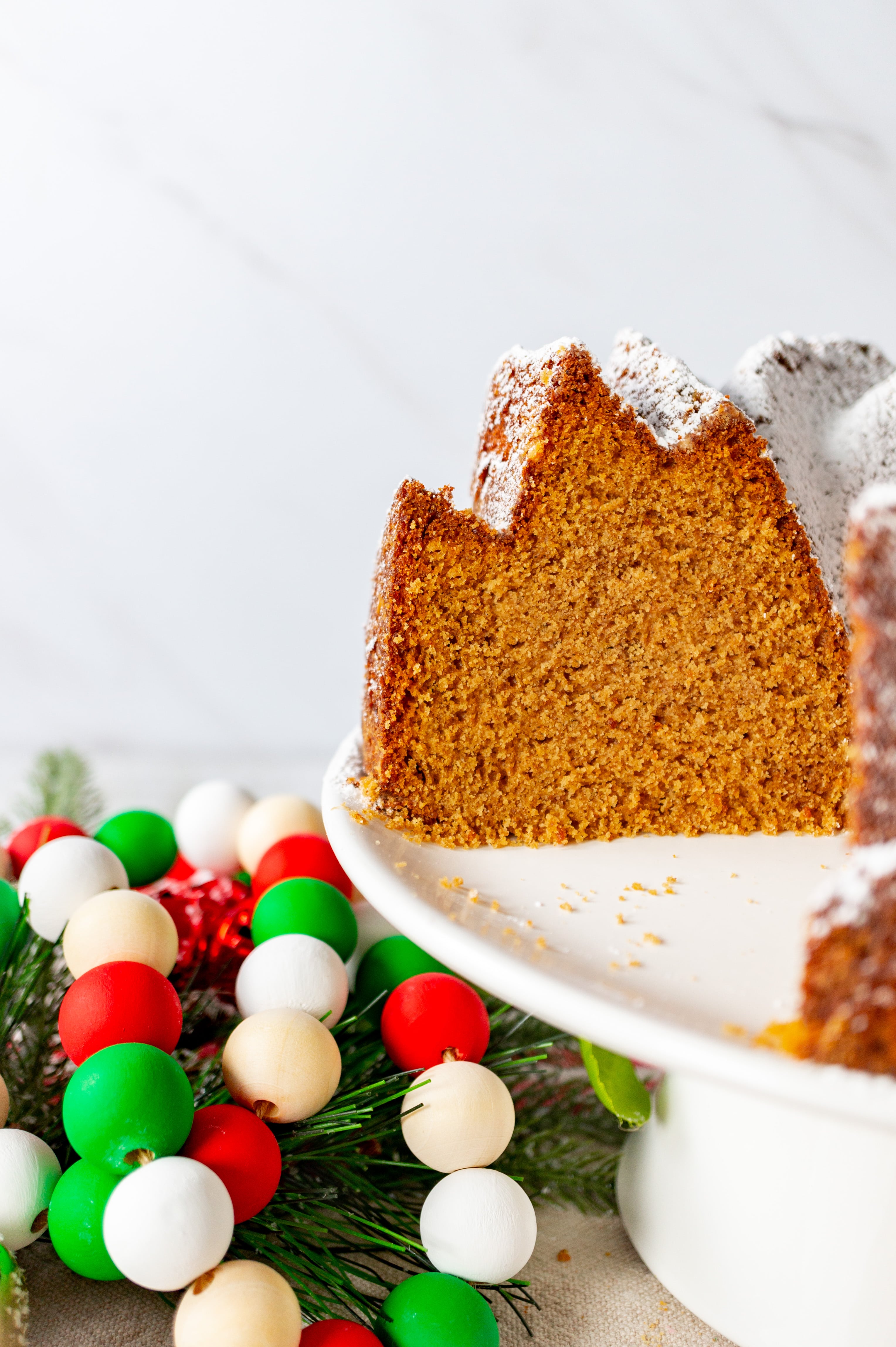 https://owlbbaking.com/wp-content/uploads/2020/11/Gingerbread-Bundt-Cake-inside-shot-with-beads-2-scaled.jpg